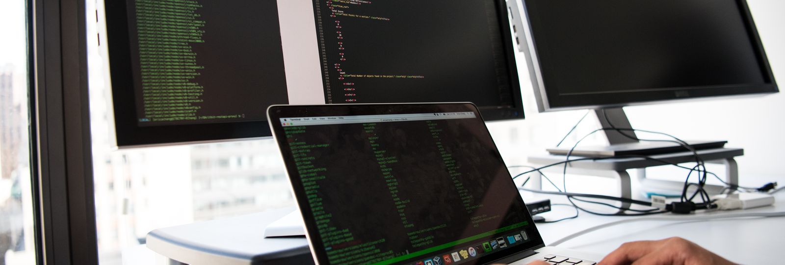 A security operator testing systems across multiple screens
