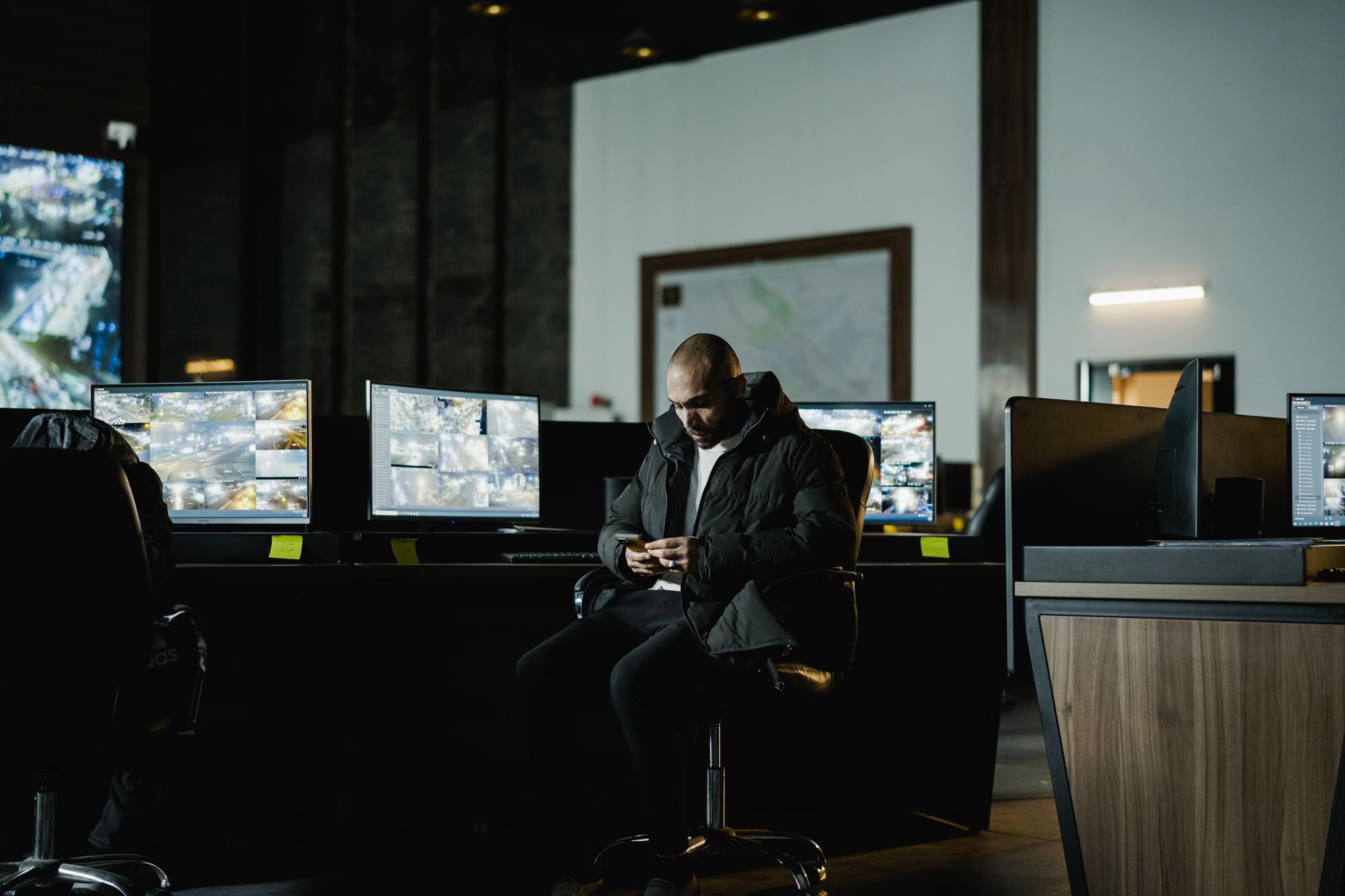A security operations center with a wall of monitoring screens